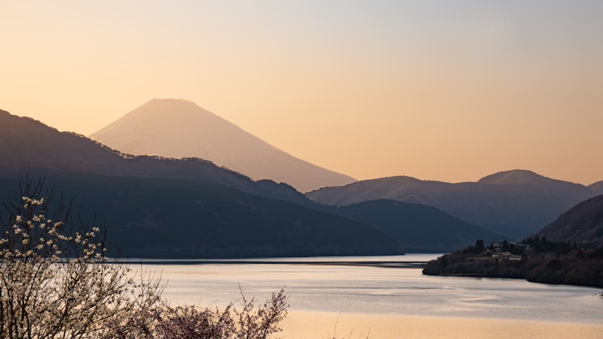 Mount Fuji at dawn above the dark hills around Lake Ashi in Hakone