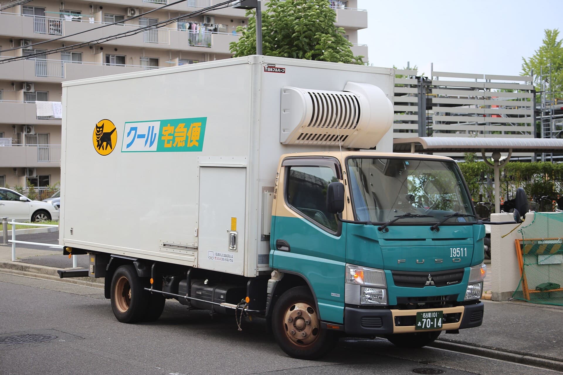 A Yamato Transport Takkyubin delivery truck with the black cat logo parked on a Japanese street