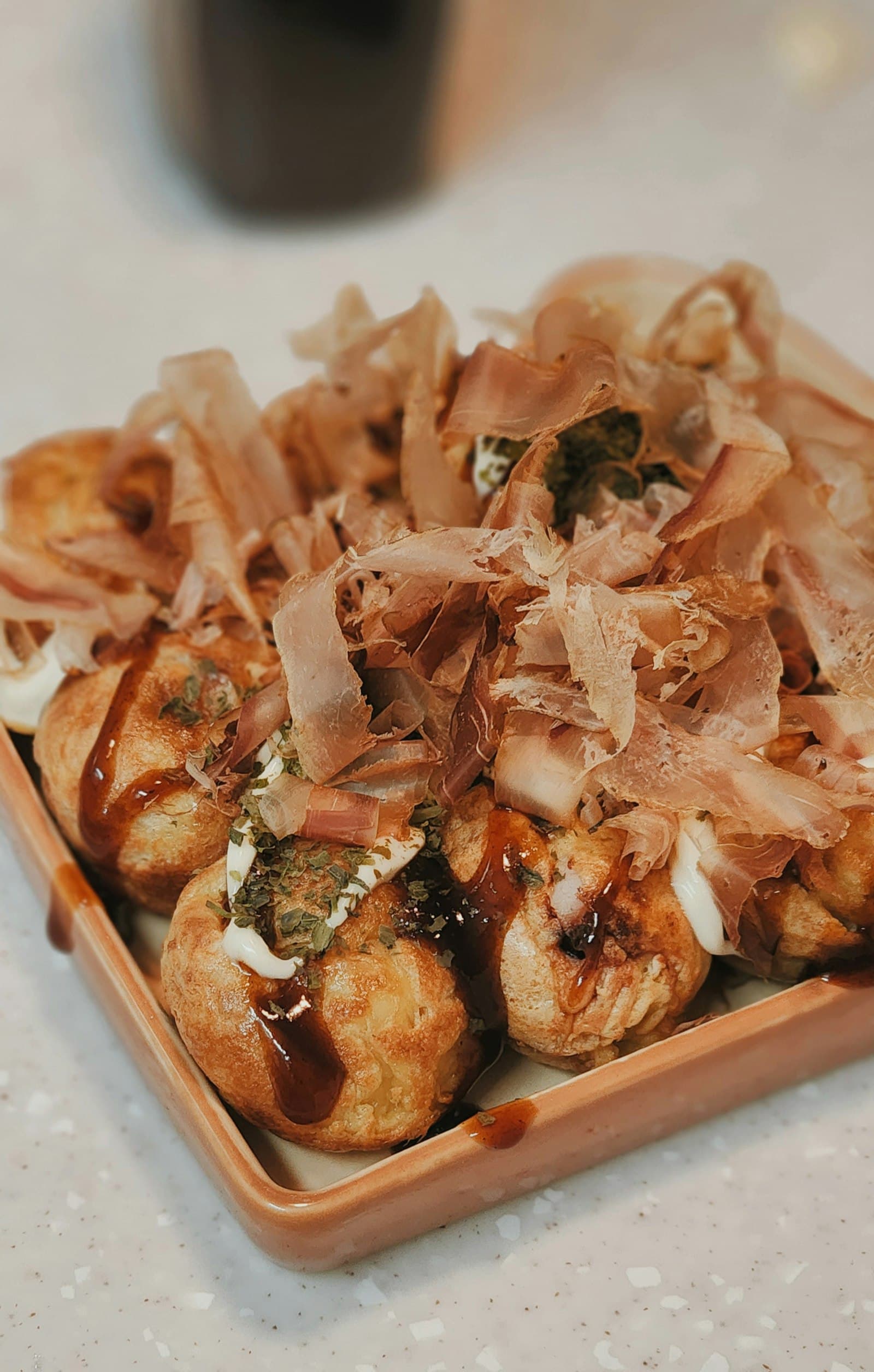 Takoyaki Japanese street food served with sauce and bonito flakes