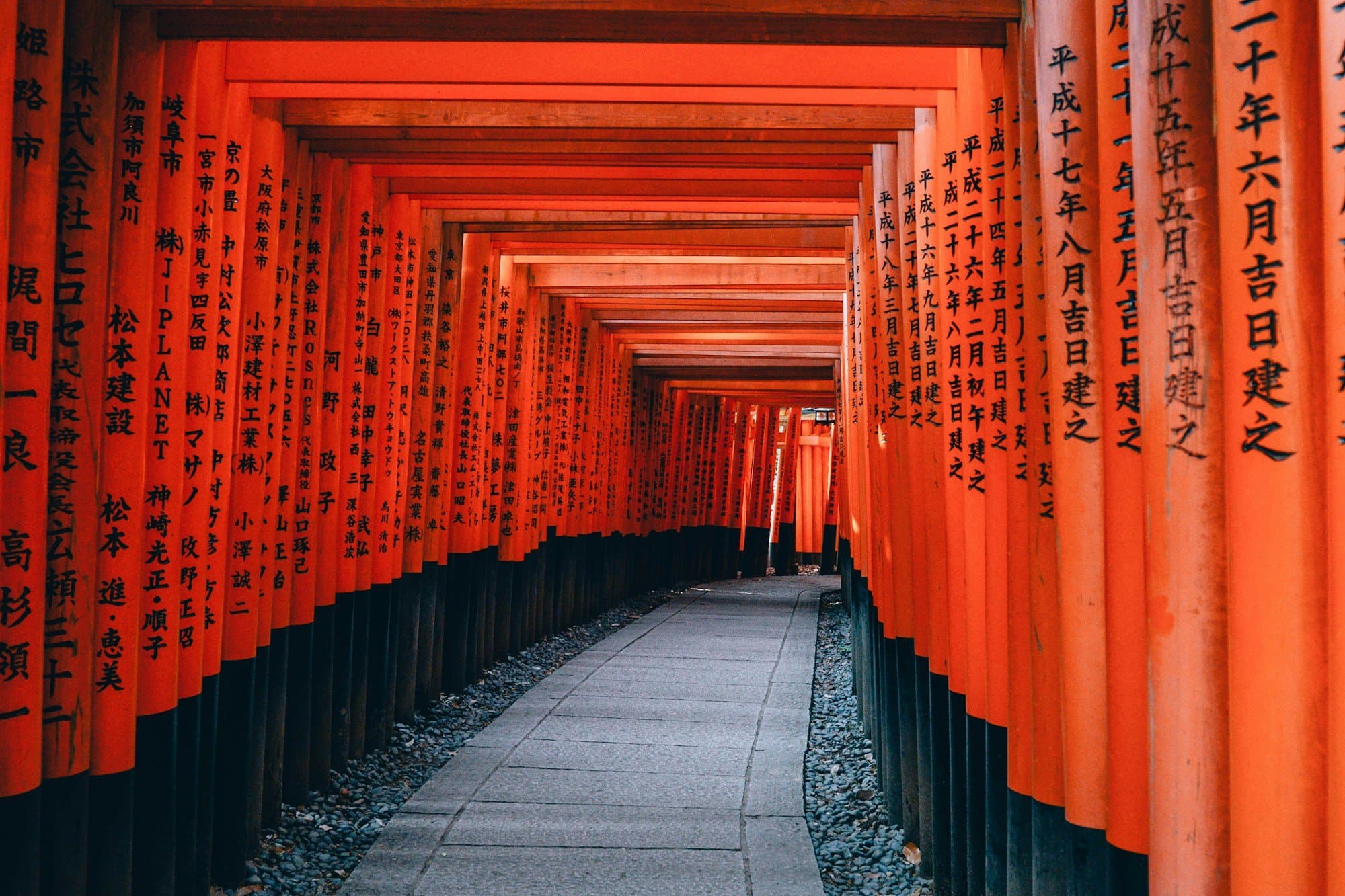 Kids running through torii gates at Fushimi Inari