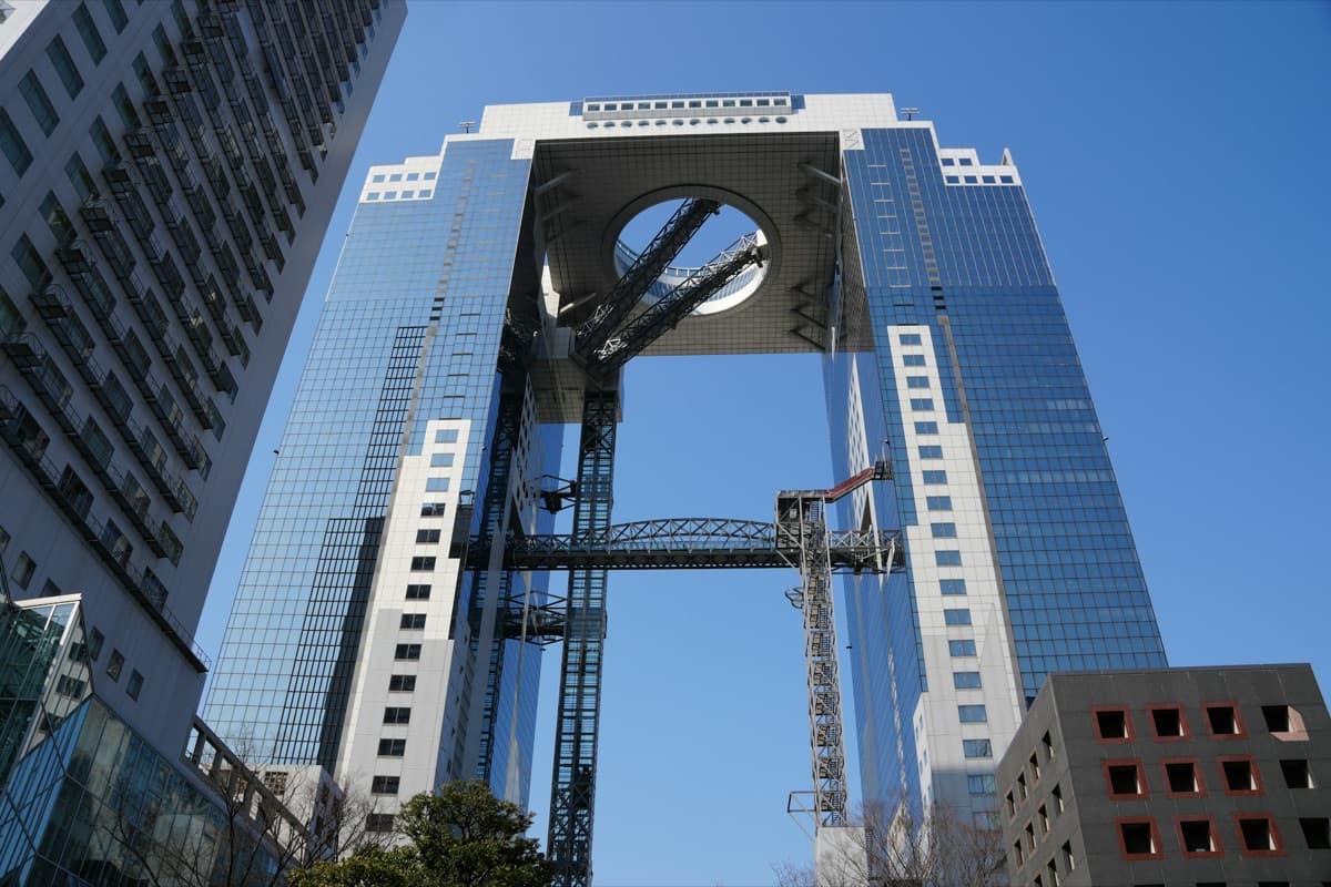 The Umeda Sky Building's two glass towers joined at the top by a bridge and rooftop observatory